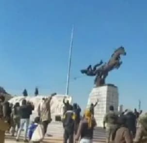 Rebels in Aleppo demolish statues of Assad's family after seizing the city