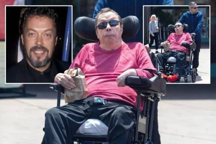 Cult actor Tim Curry, who is struggling with the effects of a stroke, was spotted on a rare walk in a wheelchair