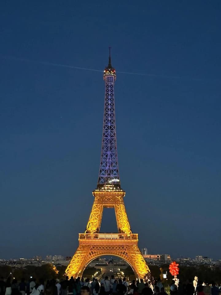 The Eiffel Tower lit up in blue and yellow in honor of Ukraine's Independence Day