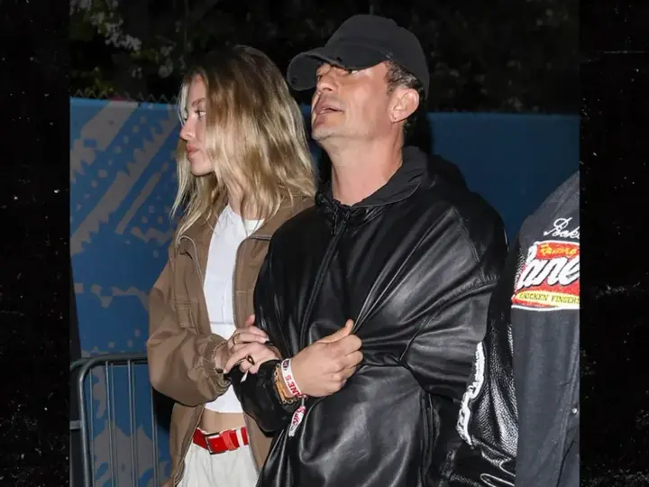 Orlando Bloom spotted with young model at Super Bowl 2026 - couple holding hands