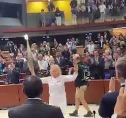 during-the-pace-meeting-the-olympic-flame-was-brought-into-the-hall