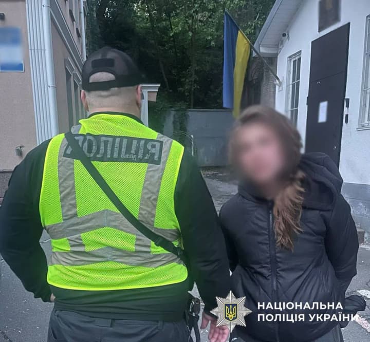 in-the-center-of-kyiv-a-woman-scattered-flowers-and-damaged-photos-of-fallen-defenders-on-the-alley-of-heroes