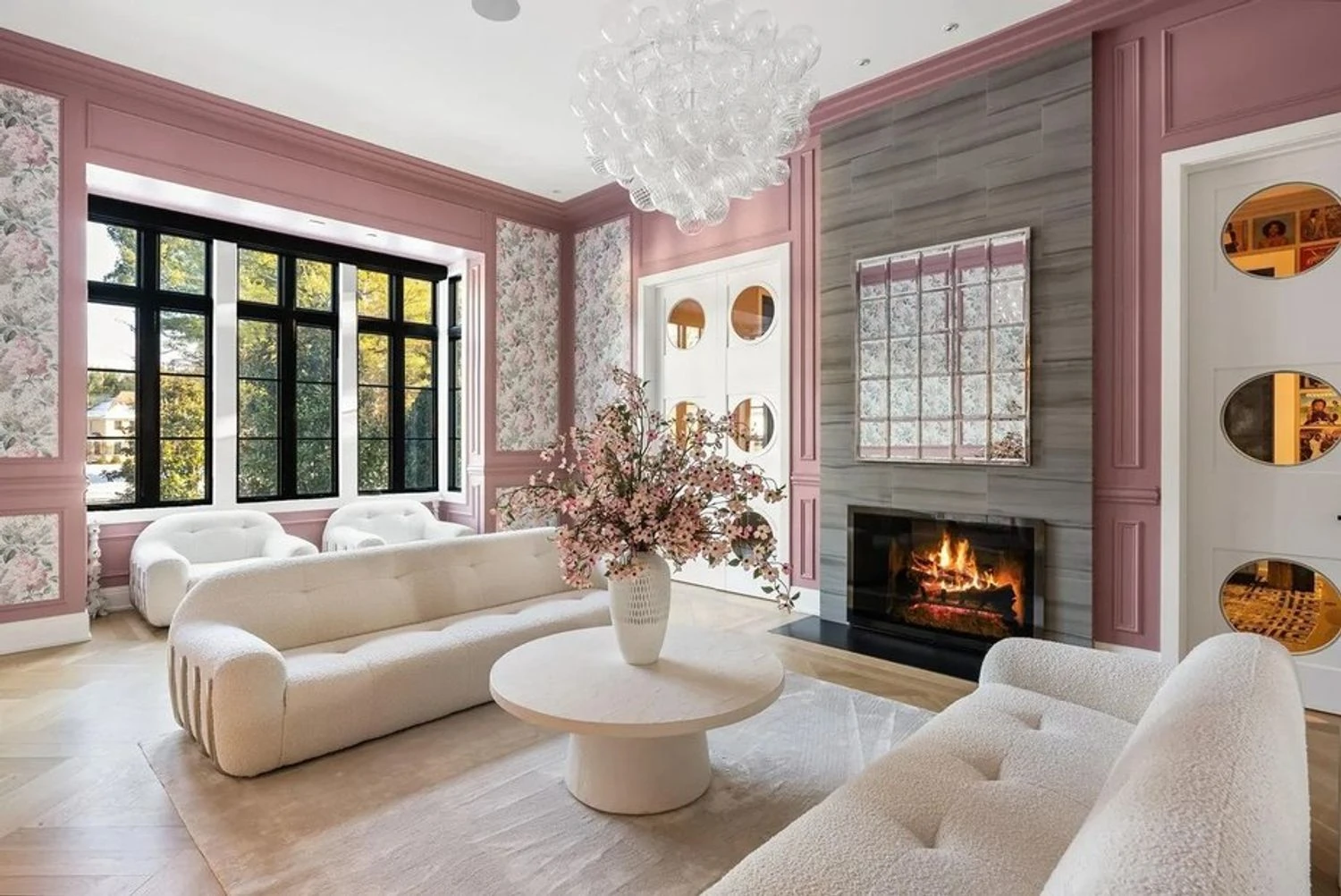 Stylish living room with designer lighting and a cozy fireplace. Realtor.com