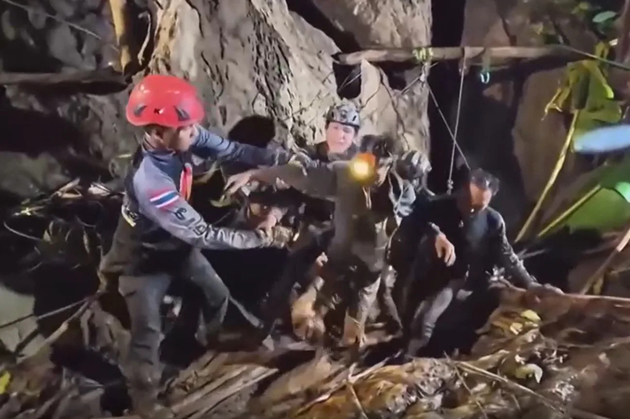 In Laos, the first of five people trapped in a flooded cave has been rescued