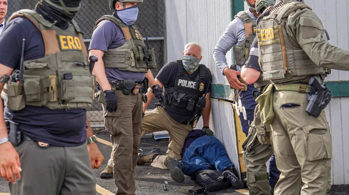 Law enforcement officers detain a demonstrator outside Delaney Hall in Newark. Photo: Reuters